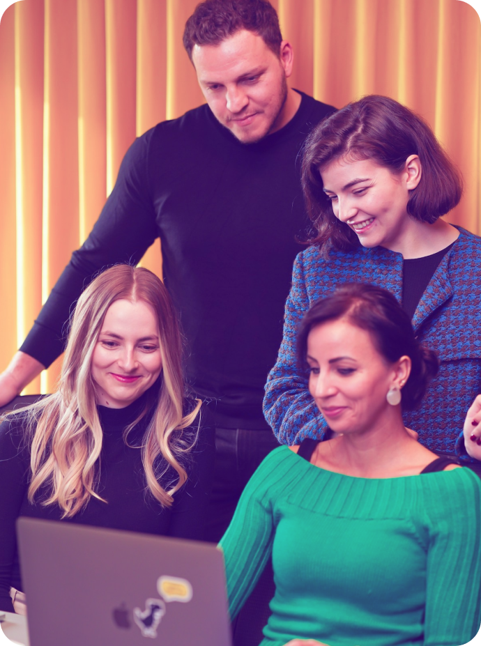 FB ads agency team reviewing campaign strategy on laptop