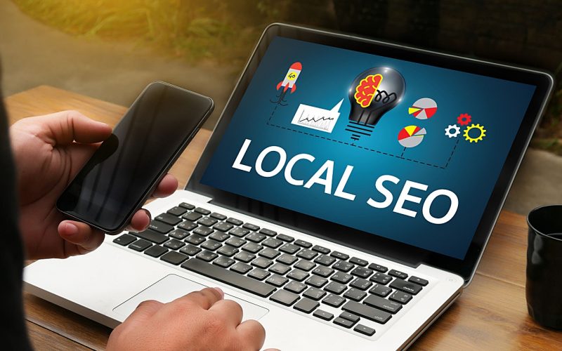 a-slideshow-describing-local-SEO-on-a-laptop-computer-that-a-digital-marketing-agency-is-showing-to-the-owner-of-a-local-business